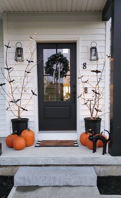 the front porch is decorated for halloween with pumpkins