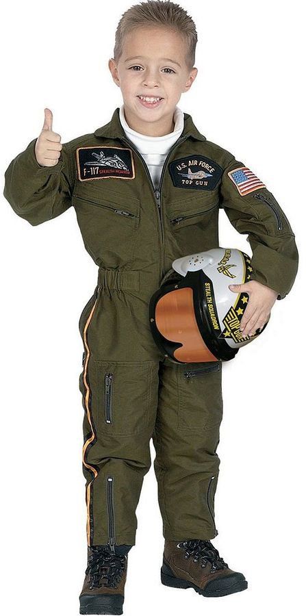 a young boy in an air force pilot suit giving the thumbs up while holding a helmet