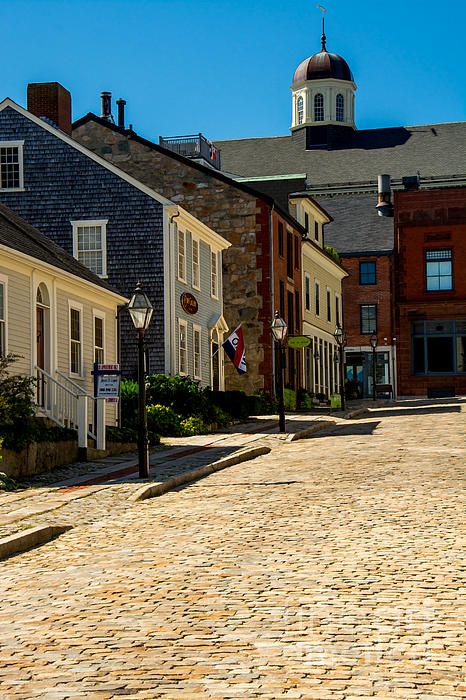 an empty cobblestone street lined with buildings