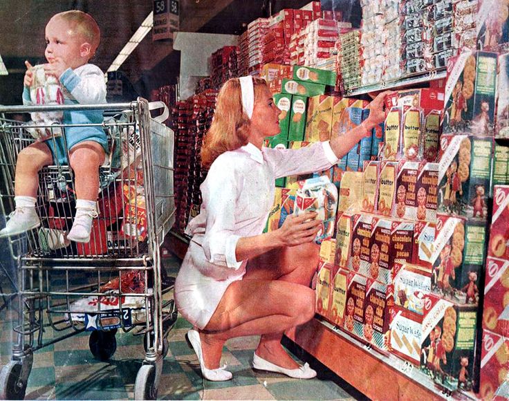 a woman and child are shopping in a grocery store with cart full of milk packets