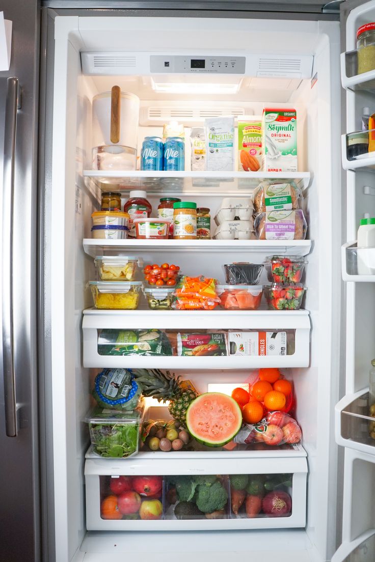 an open refrigerator filled with lots of different types of fruits and vegtables