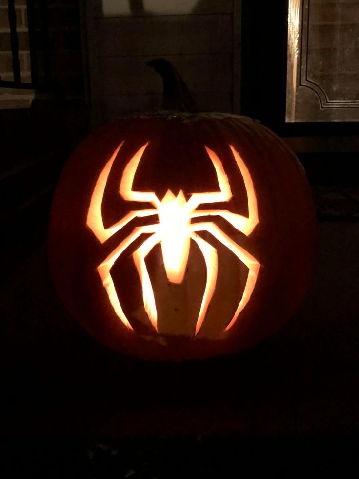 a pumpkin carved to look like a spiderman