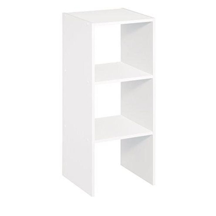 a white shelf with three shelves on each side and an open door at the top