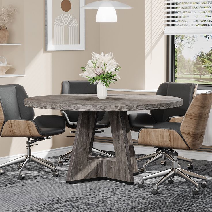 a round wooden table with four chairs around it in a room that has beige walls and carpeting