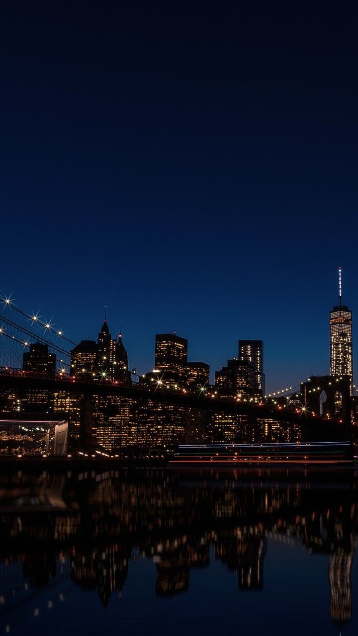 the city skyline is lit up at night