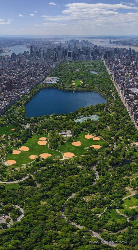 an aerial view of the central park in new york city, with many trees and grass