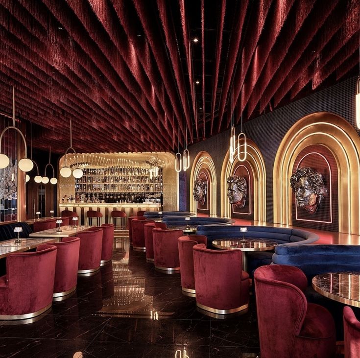 the interior of a restaurant with red velvet booths