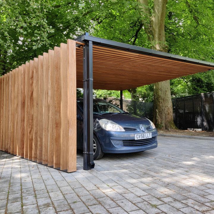 a car is parked in front of a wooden structure