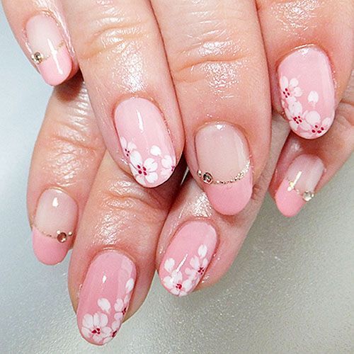 a woman with pink and white flowers on her nails