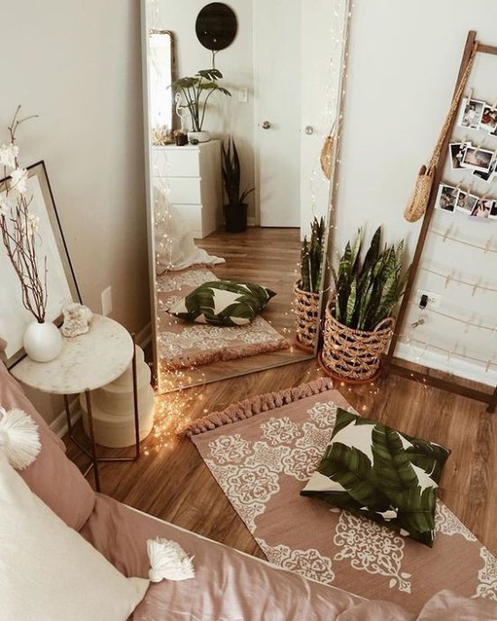 a mirror sitting on top of a wooden floor next to a plant in a pot