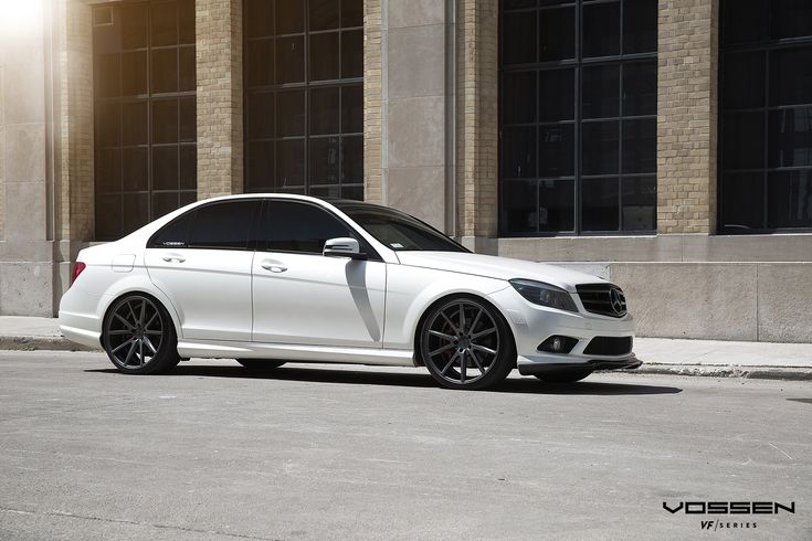 a white car parked in front of a building