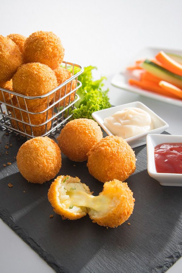 some food is laying out on a table with the words potato cheese balls above it