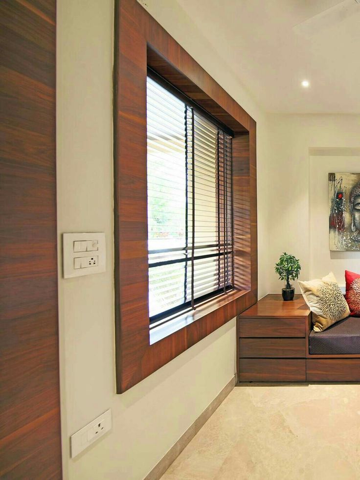 a living room filled with lots of furniture next to a wall mounted painting on the wall