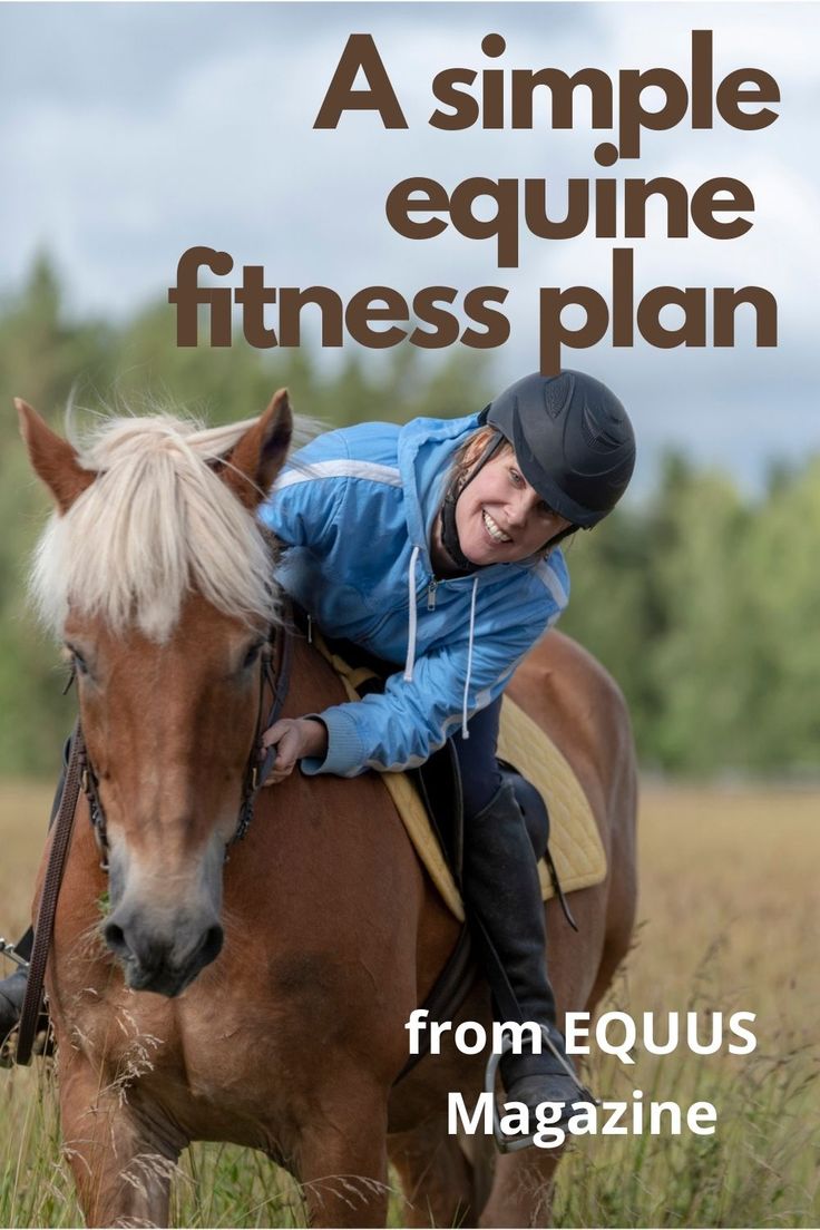 a woman riding on the back of a brown horse in a field with trees behind her