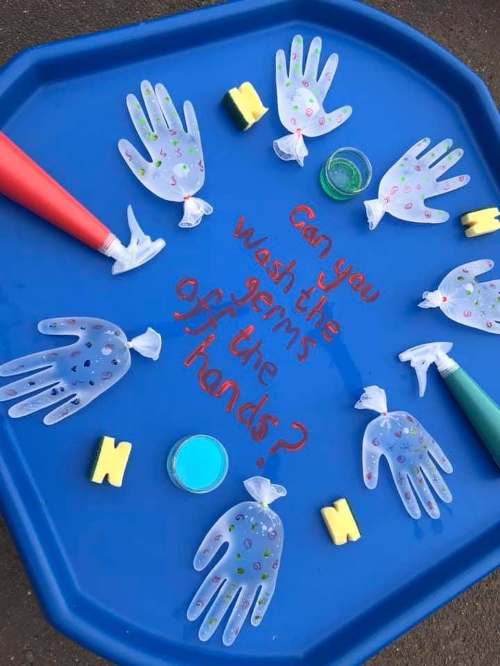 a blue tray with handprints and writing on it