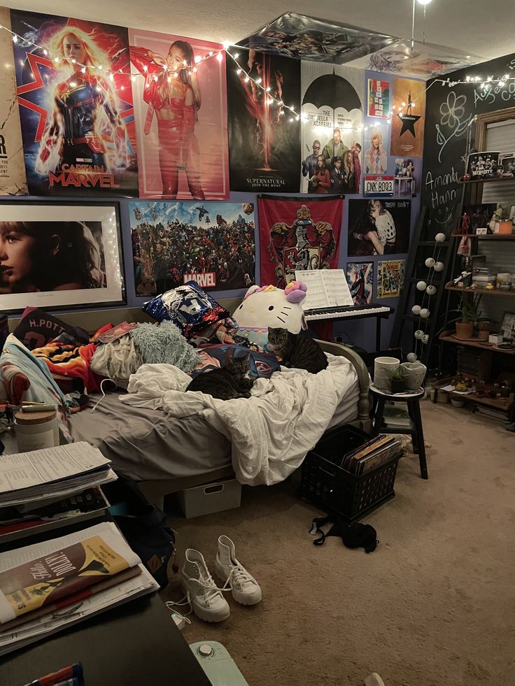 a messy bedroom with posters on the wall