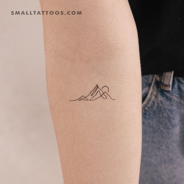 a person with a small tattoo on their arm