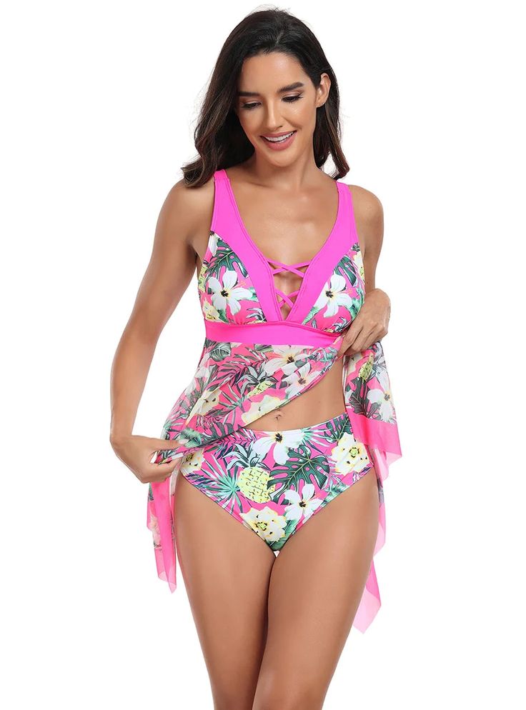 Quintessentially tropical, this swimdress is an ode to the lush vibrancy of a blooming paradise. The hot pink bodice, featuring a plunging neckline with crisscross detailing, offers both support and a daring touch. It cinches just under the bust, highlighting the waist before flowing into a handkerchief-hem skirt adorned with a vivacious floral and pineapple print. The cut provides a flattering drape that enhances movement and grace. This swimdress is crafted from a stretch-resistant, quick-dry Tropical V-neck Tankini For Summer, Tropical V-neck Swimwear With Tropical Print, V-neck Beachwear Swimwear For Summer Parties, Fitted V-neck Tropical Tankini, V-neck Swim Dress For Vacation, V-neck Tropical Print Swimwear For Summer, V-neck Tropical Print Swimwear For Vacation, Tropical V-neck Swimwear For Beach Party, V-neck Beachwear Tankini For Swimming