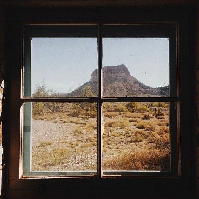 an open window with a view of the desert