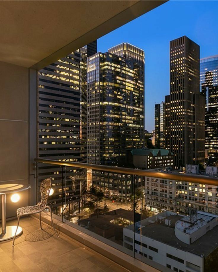 a balcony with city lights in the background