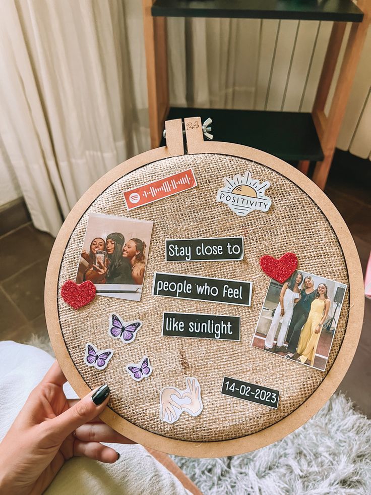 someone is holding up a cross - stitch project with pictures and words written on it