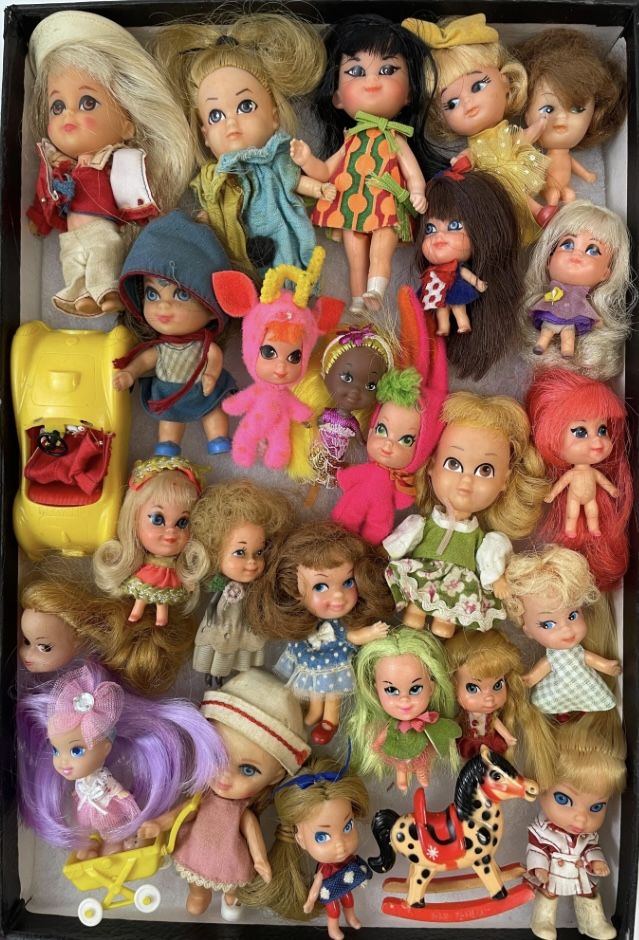 many different dolls are in a black box