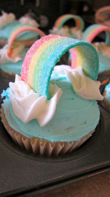 cupcakes decorated with rainbow icing and sprinkles