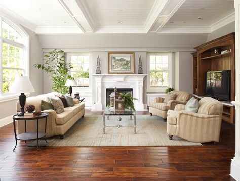 a living room filled with furniture and a fire place in the middle of a room