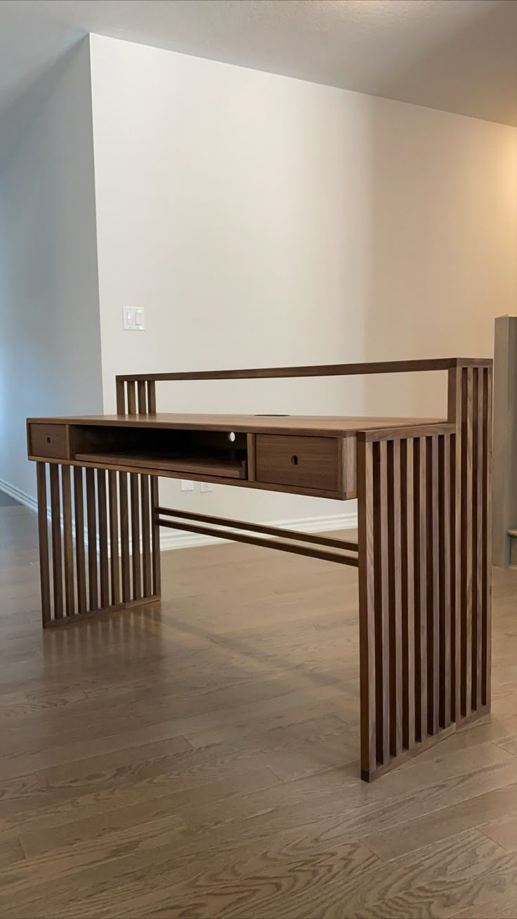 an office desk made out of wooden slats in the middle of a living room