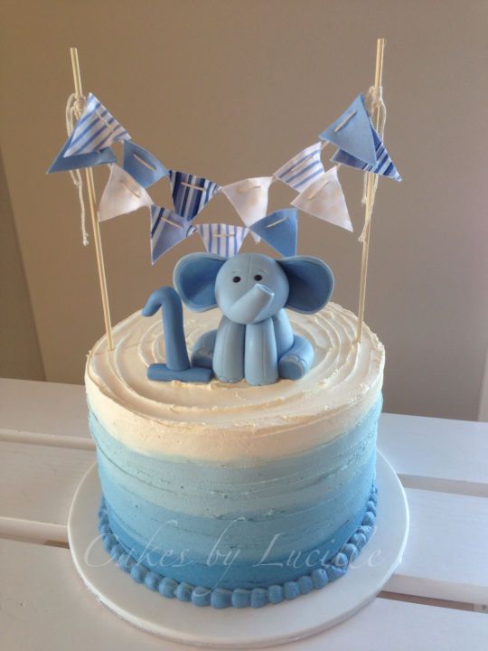 a blue and white cake with an elephant on top