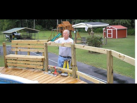 a man standing on top of a wooden deck next to a swimming pool and playground