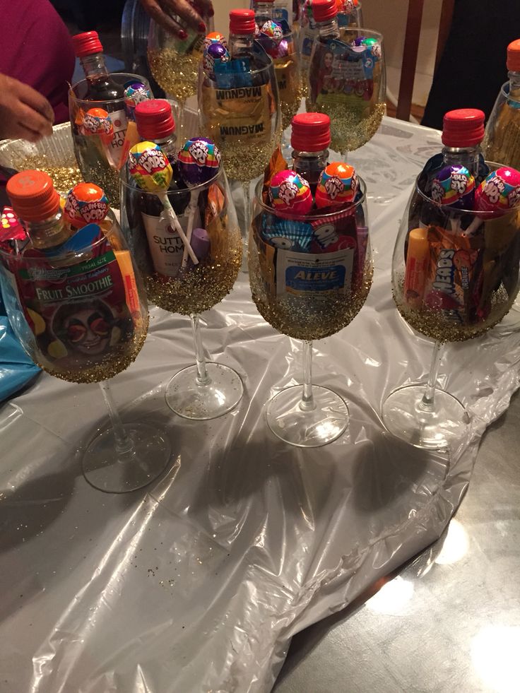 several empty wine glasses sitting on top of a table covered in confetti and sprinkles