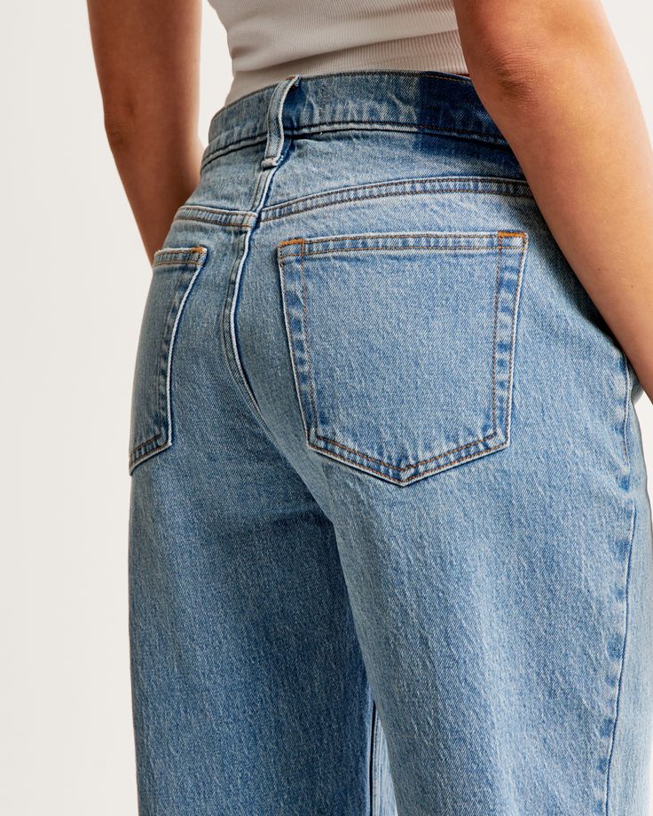 Our classic low rise baggy jeans in a medium wash with a raw hem. This fit features a 8.5” low rise, is slightly relaxed at waist and hips, and eases at the thigh into a baggy, full-length leg shape. We recommend buying your true size for a baggier fit. Size down for a closer fit. This jean is made from our vintage stretch fabric which features both an authentic vintage look and contains slight built-in stretch for additional comfort. Low Rise Baggy Jeans, Baggy Jean, Women's Bottoms, Modern Wardrobe, Low Rise Jeans, Pocket Bag, The 90s, Retro Vibe, Vintage Aesthetic