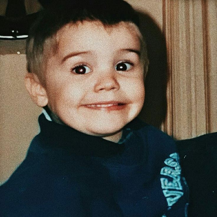 a young boy is smiling for the camera