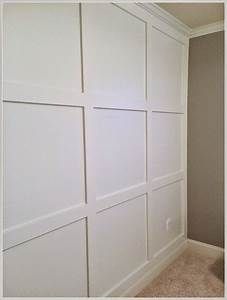 an empty room with white paneling on the walls