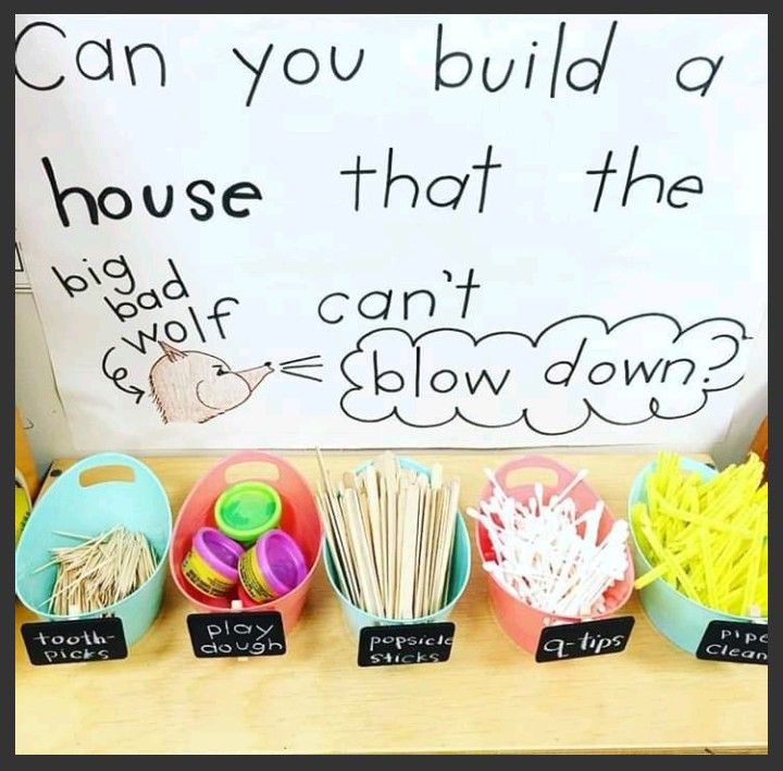 a table with bowls, cups and spoons in front of a sign that says can you build a house that the big boy can't show down?