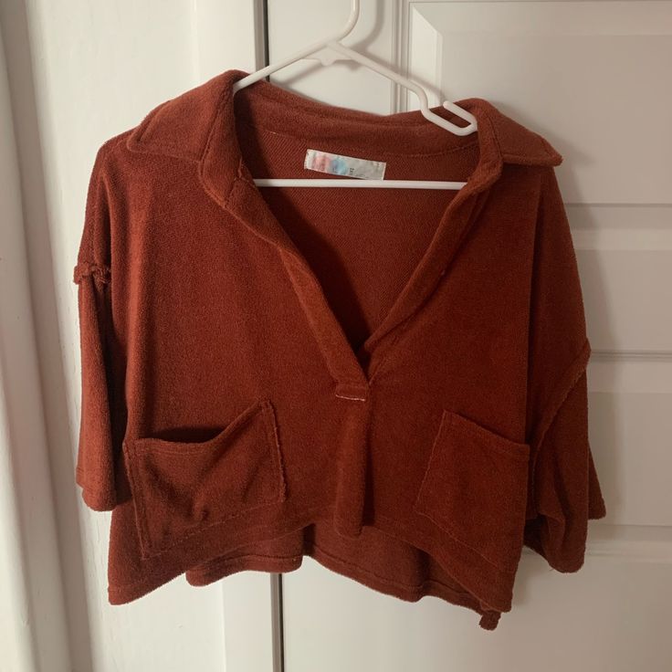 Perfect Condition. Never Worn! Color Is Kind Of A Rusty Red. Oversized Fit Oversized Cozy Collared Top, Cozy Oversized Collared Top, Oversized Brown Tops With Pockets, Fall Loungewear Sweater With Short Sleeves, Fall Loungewear Short Sleeve Sweater, Fall Short Sleeve Sweater For Loungewear, Fall Short Sleeve Loungewear Sweater, Cozy Collared Top With Relaxed Fit, Red Trendy Sweater For Loungewear