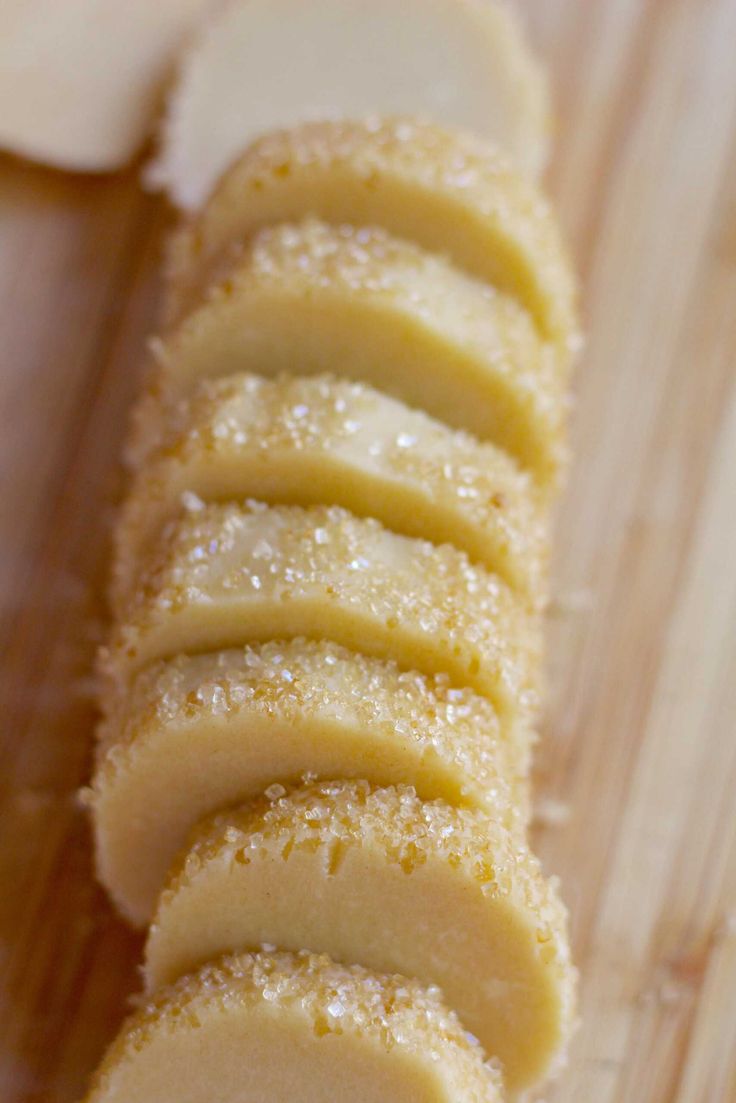 sliced pieces of bread sitting on top of a wooden cutting board