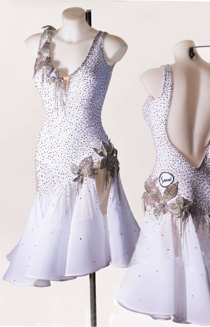 two mannequins dressed in white dresses with flowers and sequins on them