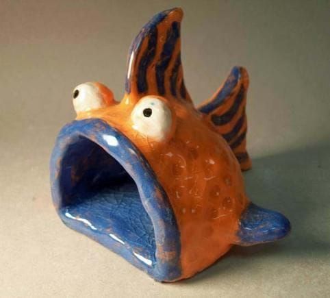 an orange and blue ceramic fish with its mouth open