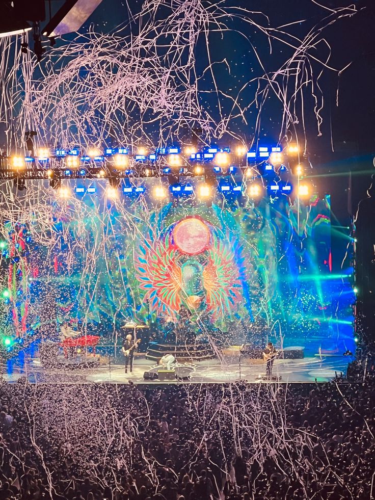 the stage is lit up with lights and confetti