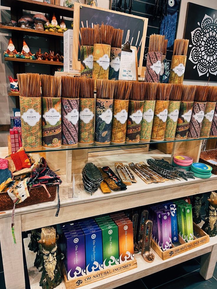 a display case filled with lots of different types of candles and incenses on top of shelves