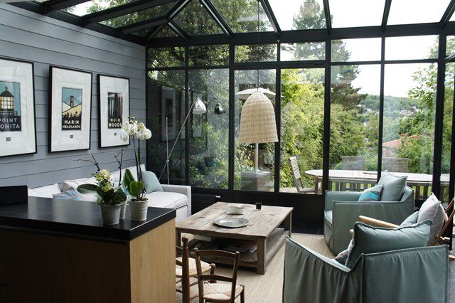 a living room filled with furniture and lots of windows