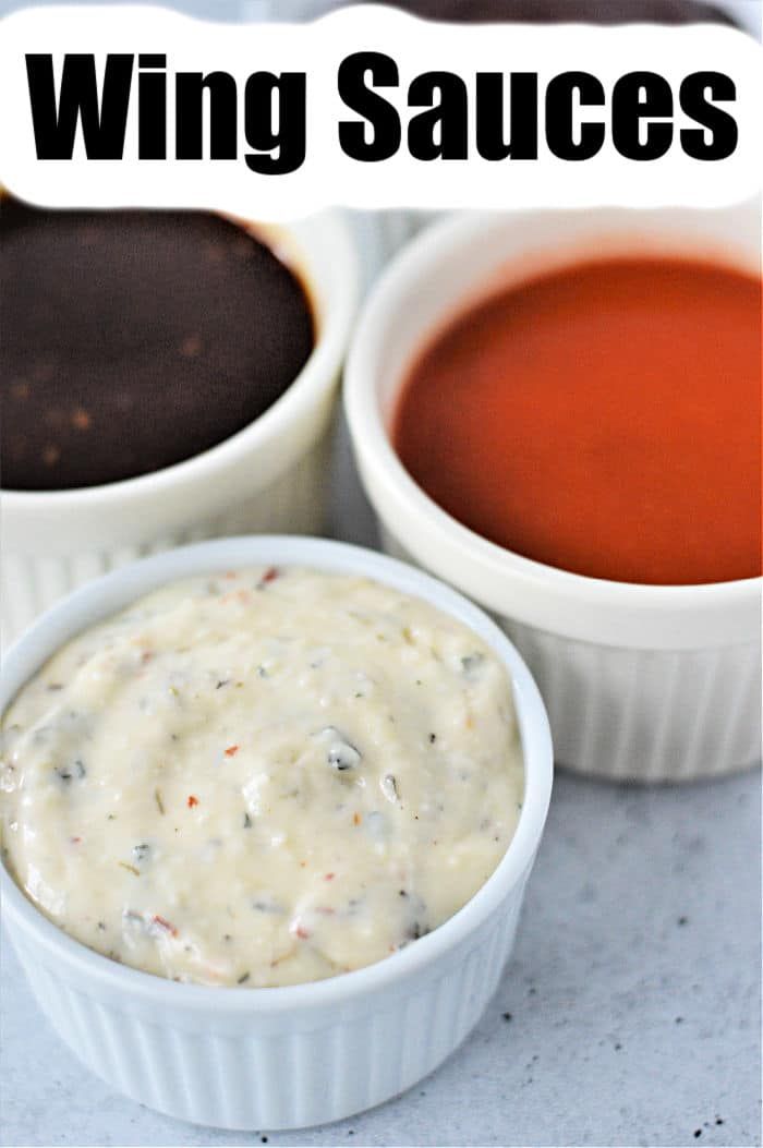 three different sauces in small white bowls with the words wing sauces above them