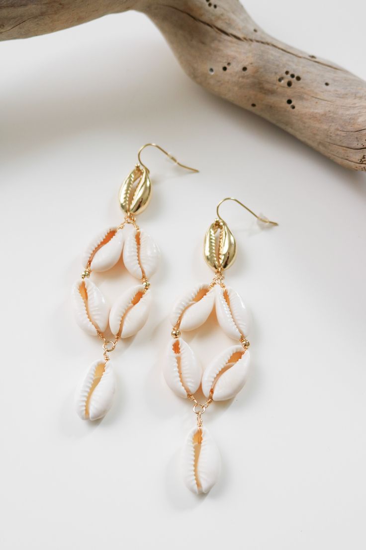 Cowry shell dangle earring. All Lauren Nicole jewelry is nickel compliant. This item is Final Sale. Elegant Nickel-free Beach Earrings, Elegant Nickel-free Earrings For The Beach, Metal Drop Earrings For Beach, Beach Drop Earrings In Metal, Beach Metal Drop Earrings, Shell-shaped Jewelry With Matching Earrings For The Beach, Single Dangle Earring For Beach, Shell-shaped Metal Earrings, Beach Beaded Metal Earrings