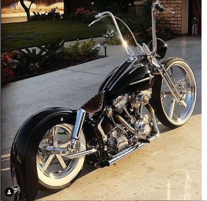 a black and chrome motorcycle parked in front of a house