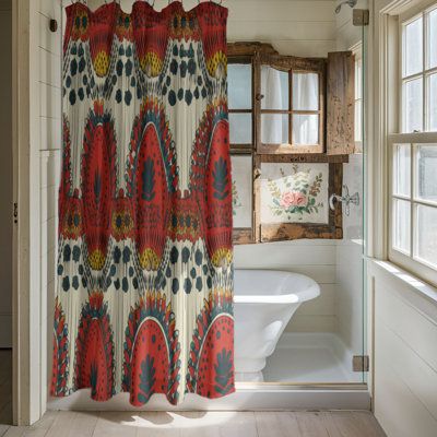 a bathroom with a shower curtain and tub