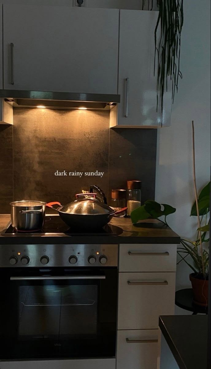 a stove top oven sitting inside of a kitchen