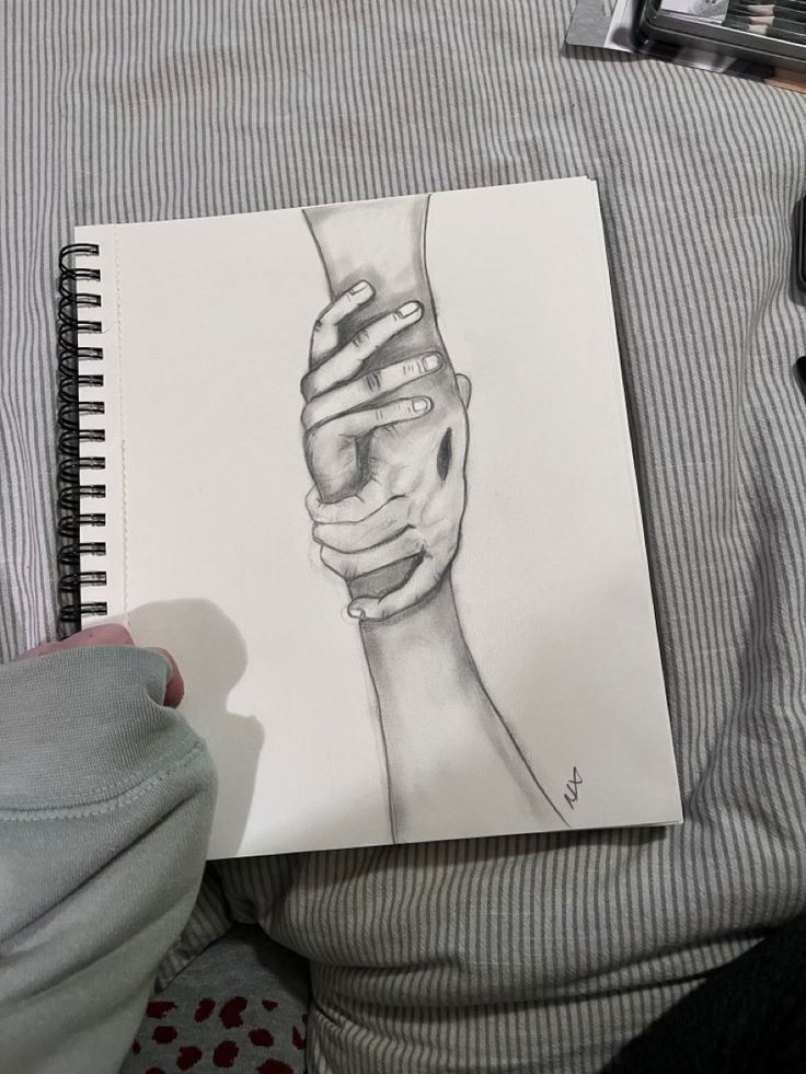 a drawing of a person's hand holding the wrist of another person with their arm wrapped around each other