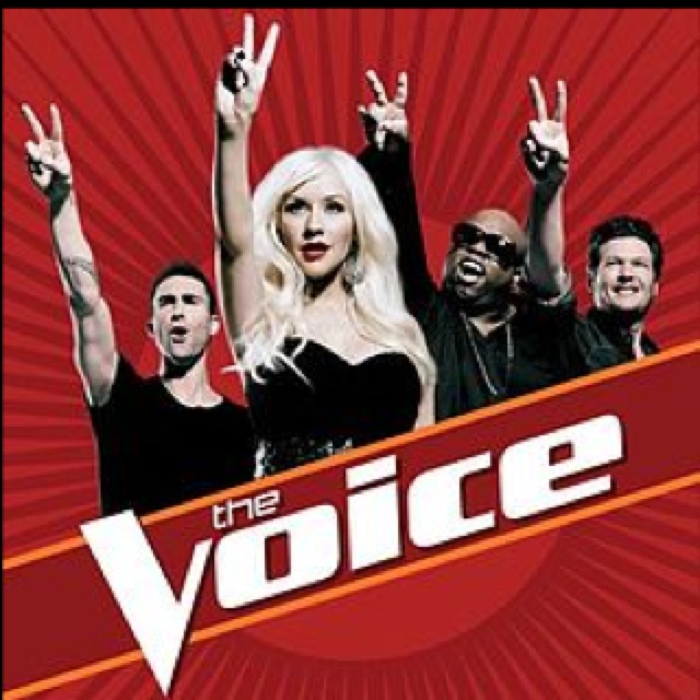 the voice cast on stage with their hands in the air